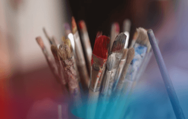 Used paintbrushes in a container